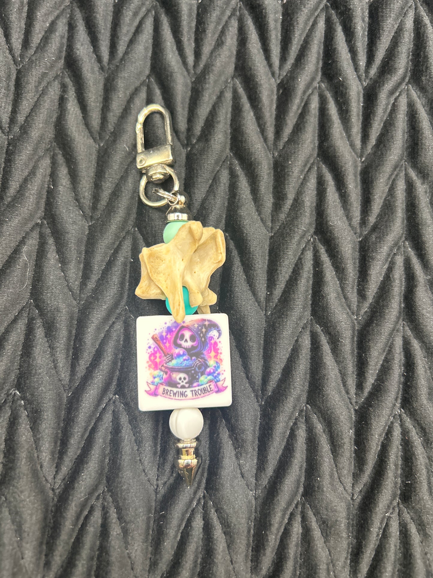 Vertebrae Keychain ("Brewing Trouble")